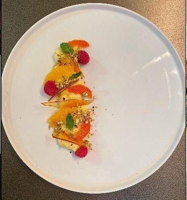Deconstructed crème brûlée with pistachio and blood orange, plated by private chef Jackson Locklear